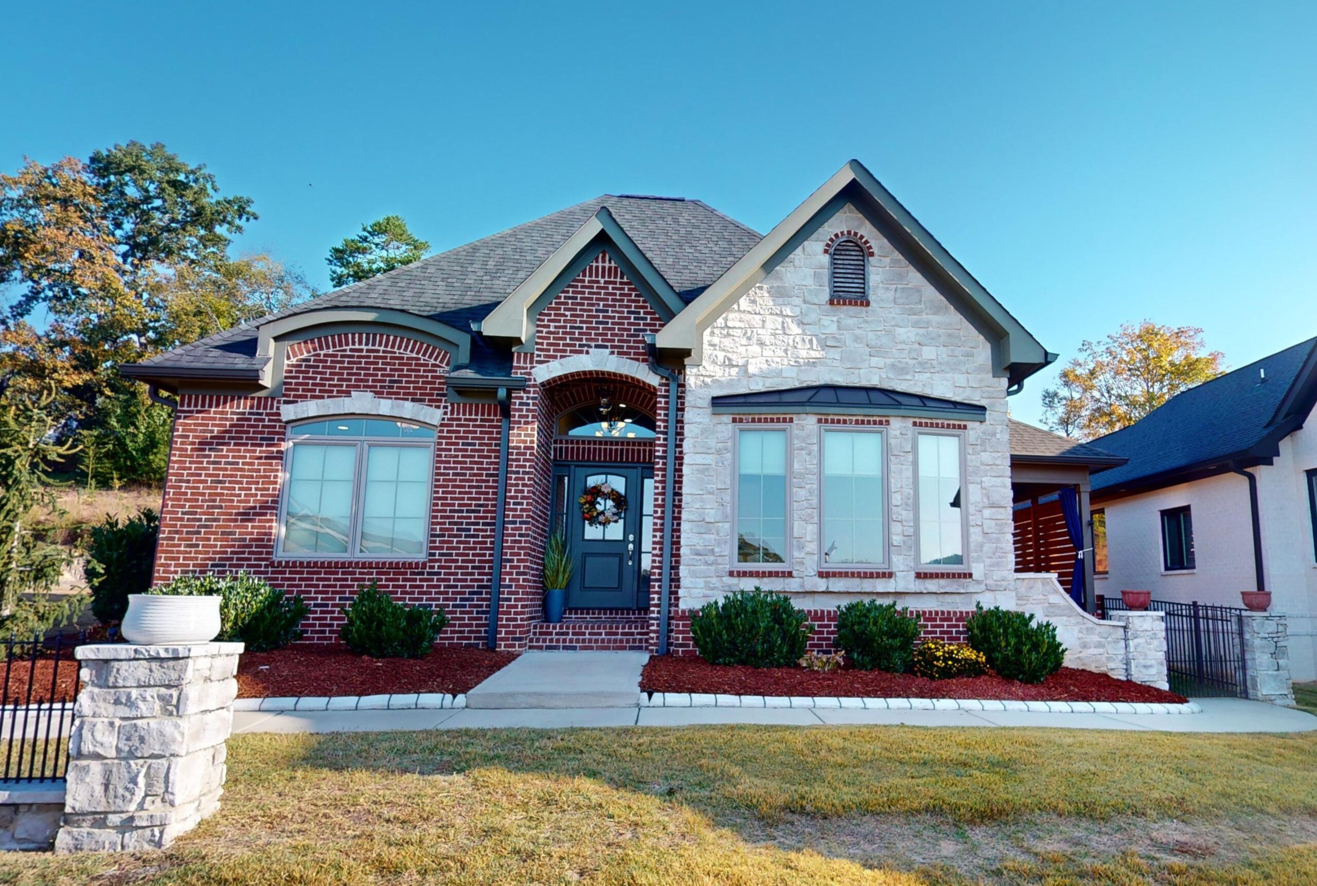 Front of 2664 Copper Cove, home for sale in Ooltewah TN. 1 story brick home with white stone accent on right. Front door is set in a a stoop.