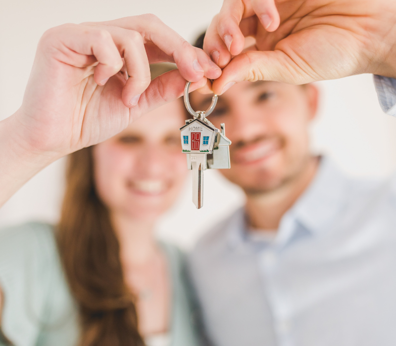 Picture of a couple holding a key to a home